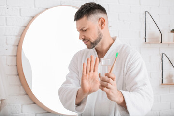 Man refusing to brush teeth in morning