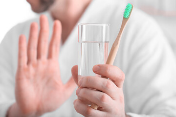 Man refusing to brush teeth in morning