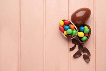 Chocolate Easter eggs on color wooden background