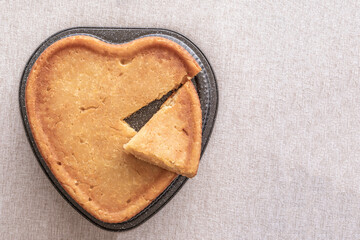 Heart shaped Lemon Brownie Cake on rustic background.