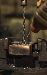 Drilling a hole in a gripped work piece on a drilling machine