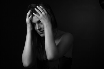 black and white portrait of an adult woman in a studio on a black background.