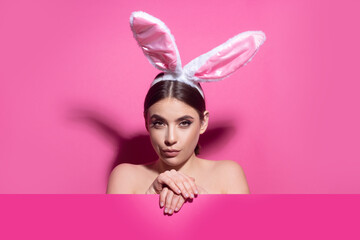 Portrait of a pretty lovely girl wearing bunny ears isolated on pink banner, copy space. Blank poster banner.