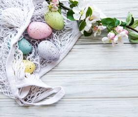 String bag with Easter eggs and spring blossom