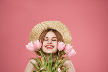 cheerful woman with bouquet of flowers cropped view pink background