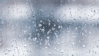 Raindrops on the glass window as a background.