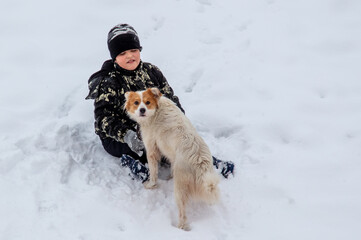 Boy with a dog in the snow