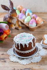 Easter still life with cake, homemade cookies, decorative figurine of rabbit