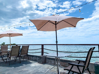 chairs and umbrella with beach view with holiday concept.