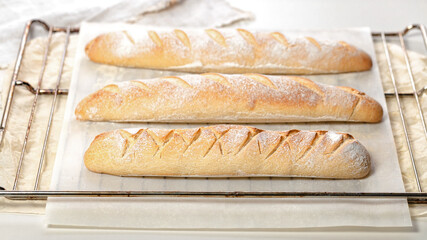Homemade fresh mouth-watering sourdough baguettes. Homebaked bread. Horizontal shot