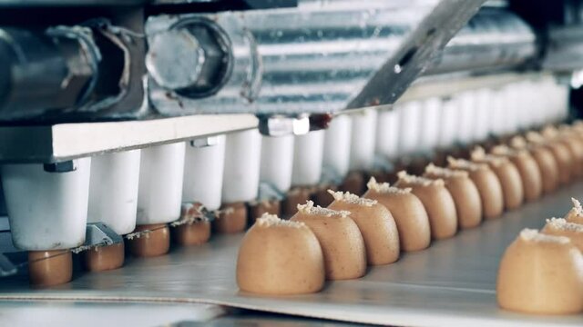 Close up of fudge candies getting mechanically fabricated