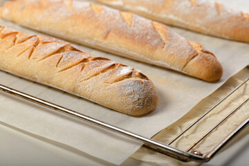 Close-up homemade fresh mouth-watering sourdough baguettes. Homebaked bread.