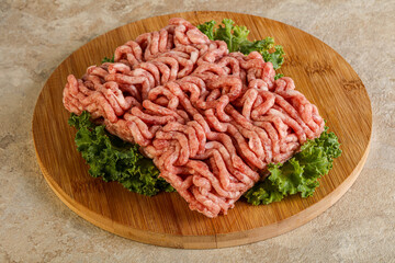 Raw pork minced meat over board