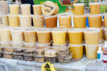 Raw honey, propolis, wax and honeycomb in prastik buckets and co