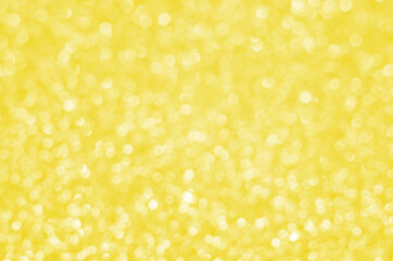 Illuminating Pantone Color Of The Year 2021. Abstract festive bokeh background with shining defocus sparkles. Blurred glitters shimmering dust macro close up, copy space for text logo