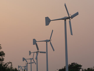 windmills in the fields in the evening time