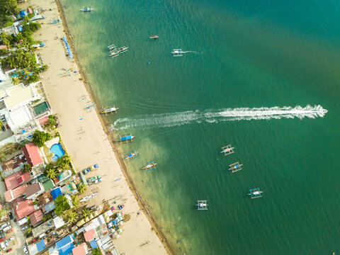 Top view of a resort town and beach. A visible stream caused by a jet ski moving to deeper waters. At Calayo, Nasugbu, Batangas.