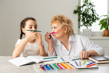 Grandmother with little girl doing homework