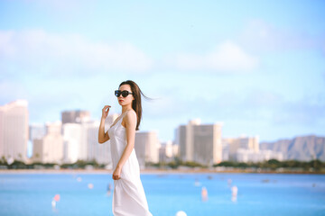 Girl wearing white long dress by the sea, Honolulu, Oahu, Hawaii