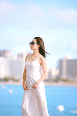 Girl wearing white long dress by the sea, Honolulu, Oahu, Hawaii