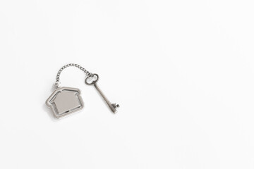 Home key with house keychain on white background