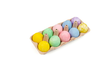 Fototapeta na wymiar Natural dye Easter eggs in carton tray isolated on a white background