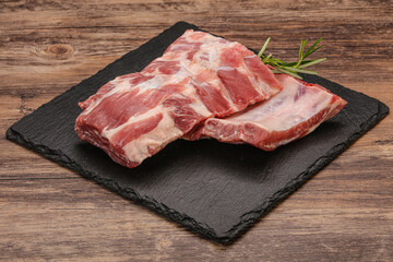 Raw pork ribs served rosemary