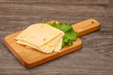 Sliced yellow cheese over board