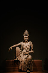 Fototapeta na wymiar Buddha statue at Honolulu Museum of Art, Oahu, Hawaii. A Guanyin Bodhisattva woodcarved Buddha statue from the Song Dynasty, China.