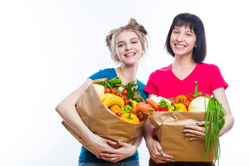 Healthy Eating and Lifestyle. Portrait of Young Caucasian Girlfriends Holding Shopping Bag With Vegetables.Horizontal Shot