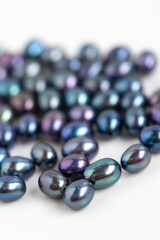 Dark Peacock Oval Pearls. Natural Freshwater Pearls on white