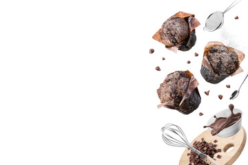 Chocolate muffins or cupcakes with set of kitchen utensils on white background. Copy space.