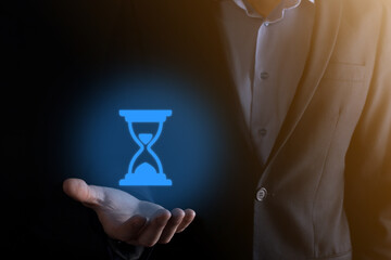 Businessman man holds in hand hourglasses icon. Time expires. A reminder to action. Business concept. Elements for design.