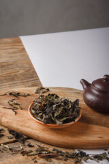 Chinese tea. Dry loose Chinese tea leaves on wooden background. Space for text.