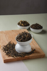 Chinese tea. Dry loose Chinese tea leaves on wooden background. Space for text.