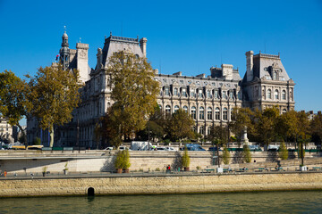 View of impressive architecture of Paris City Hall on bank of Seine river on sunny autumn day, France