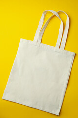 Blank eco bag on yellow background, space for text