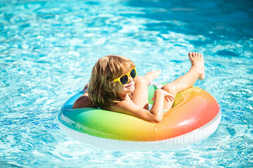 Summertime vacation. Summer kids weekend. Boy in swiming pool. Child at aquapark. Funny boy on...