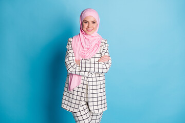 Photo of young arabian woman happy positive smile folded hands confident wear hijab isolated over blue color background