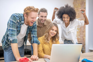 Young professionals working in the office together and looking happy