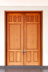 Large teak wood doors light brown entrance to the meeting room