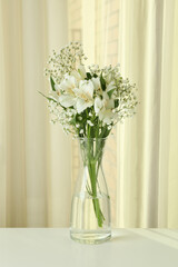Vase with beautiful alstroemeria and gypsophila flowers