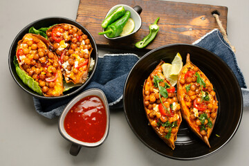 Stuffed sweet potato with spiced chickpea, dressing and herbs.