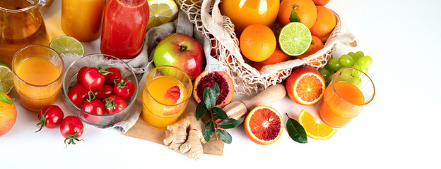 Healthy home made juices and fruits on light wooden background