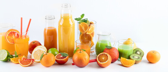 Raw fresh citrus juices and fruints in glasses and bottles