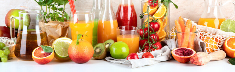 Healthy home made juices and fruits on light wooden background
