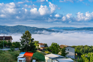 Foggy view from the hills of San Capone to the Sibillini mountains park in Italy