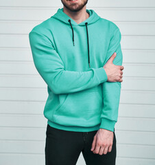 bearded guy wears blue hoodie. no logo color hoodie. clothing line mock up