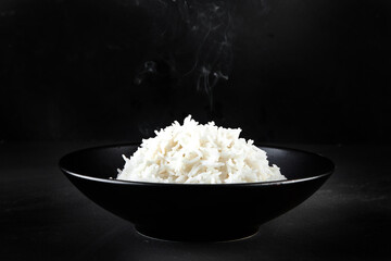 Hot boiled rice in japanese bowl on black background