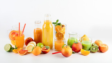 Variety of citrus juices and fruits on white background